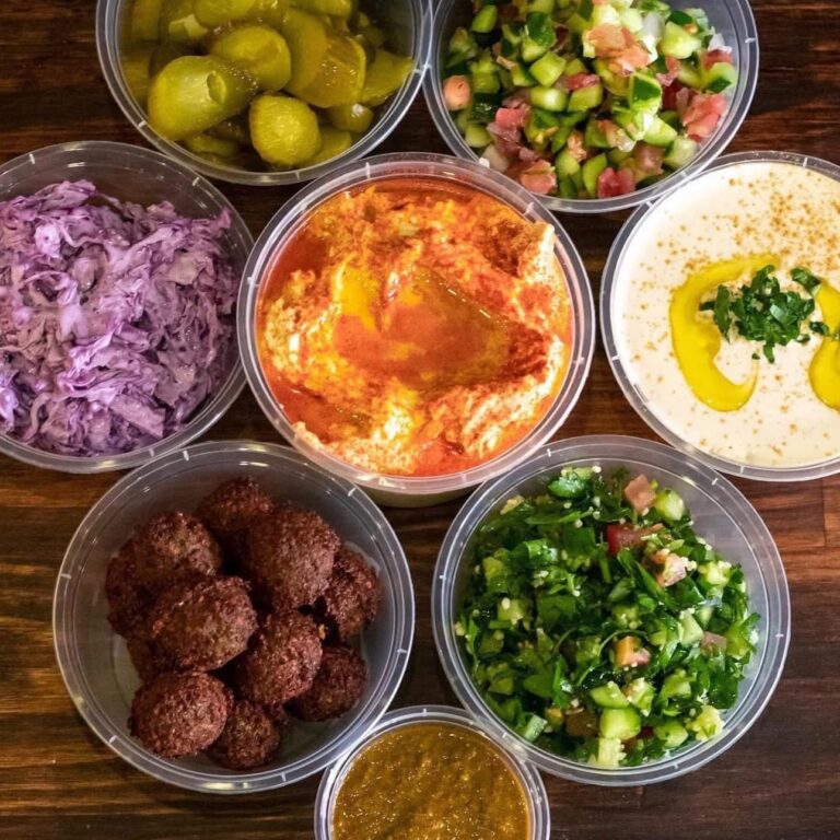 Hummus, tabouli, Israeli salad and falafel in serving bowls