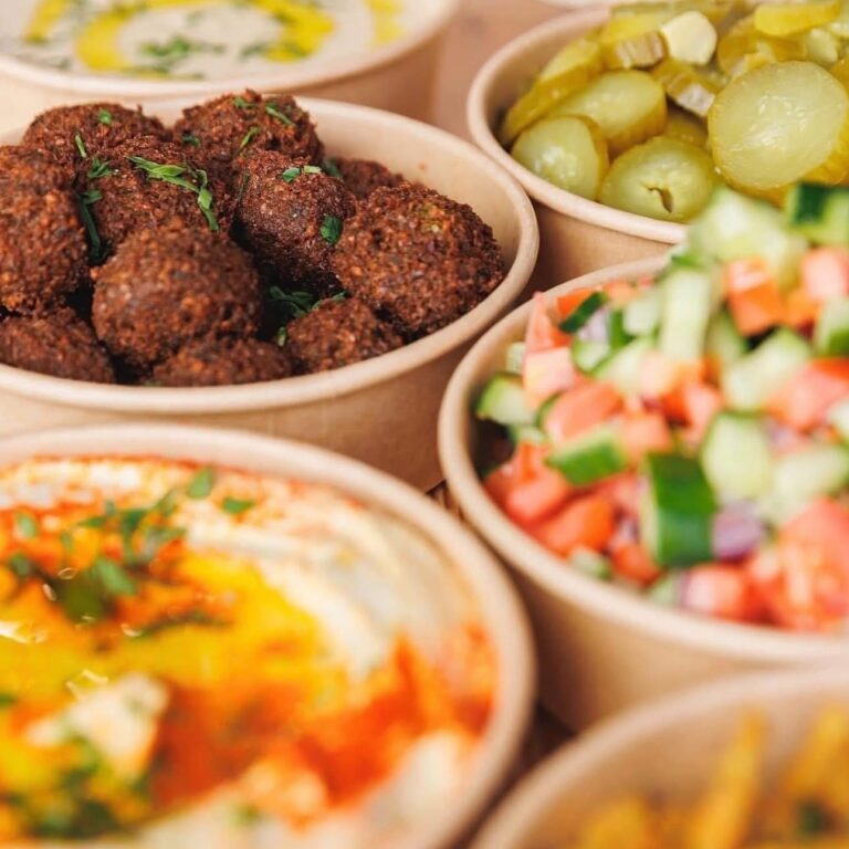 Bowls of dips and pickles with fresh pita for a party