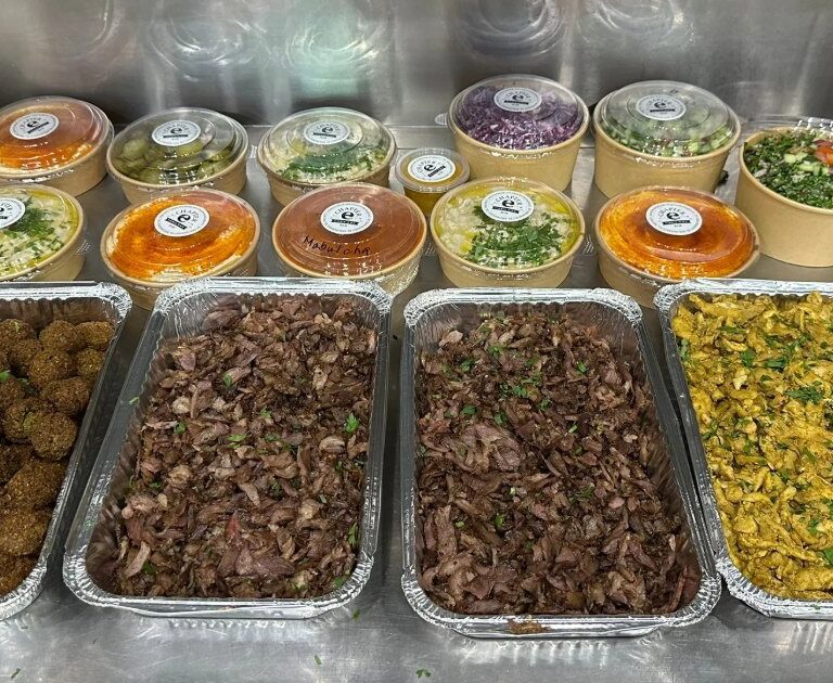 Catering trays of falafel, lamb and chicken shawarma with rice and salads